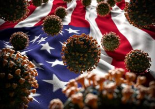 COVID-19 virus cells in front of an American flag